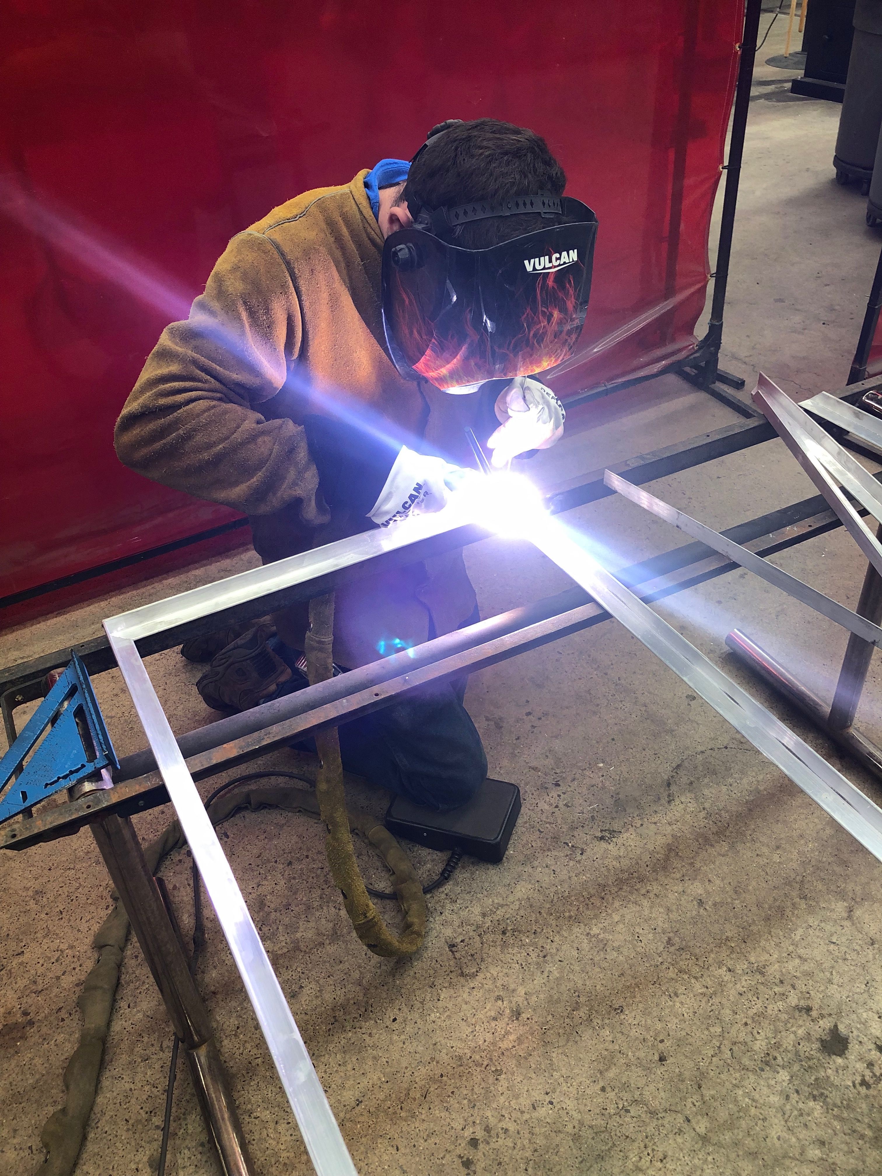 Jimmie TIG welding his final project in his welding certification program - a set of aluminum solar panel frames for the family RV.