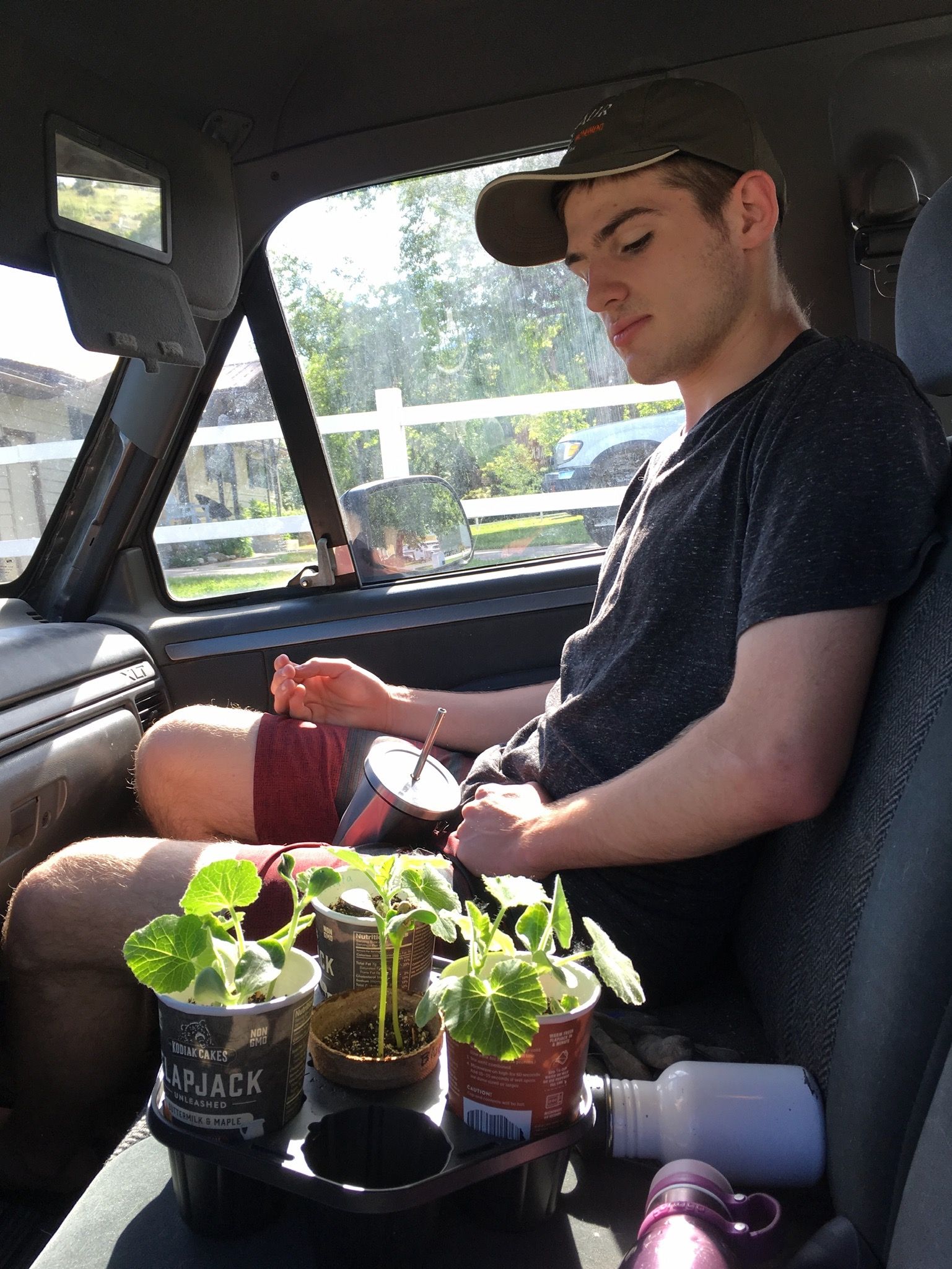 Derek in the farm truck - looking fondly at his seedlings.